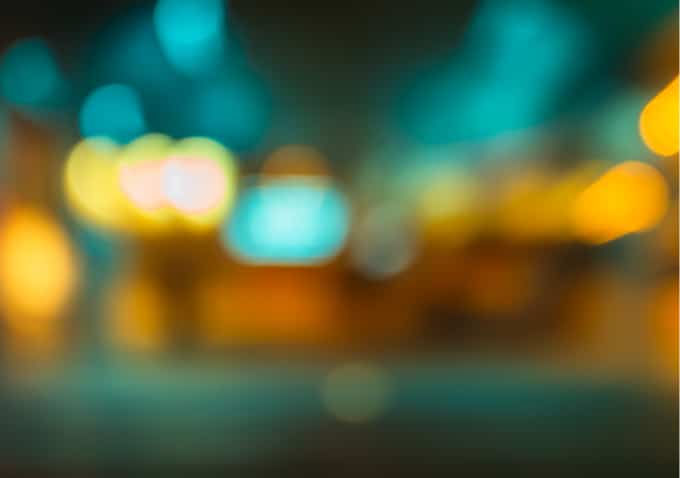 Defocused teal and amber city lights at night