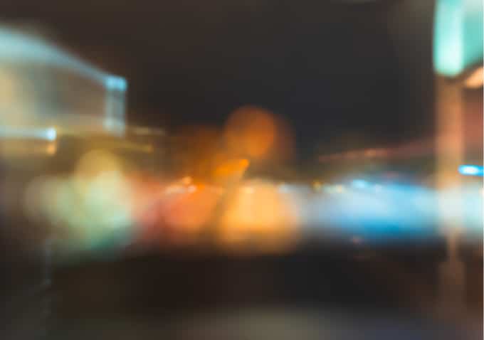 Blurred nighttime city lights with orange and blue bokeh